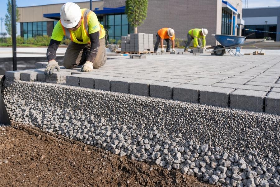 Permeable paver installation showing base layers and crew
